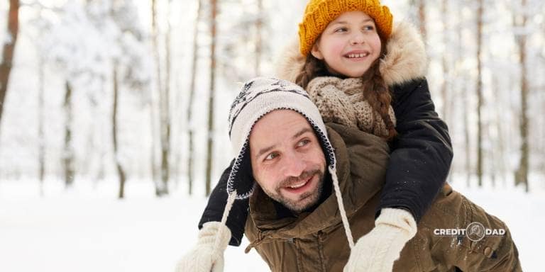 Budget-Friendly Family Activities This Winter Father and daughter enjoying a budget-friendly winter day outdoors, highlighting affordable family activities.